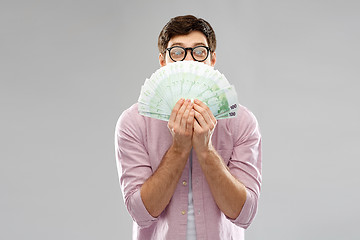 Image showing happy young man in glasses with fan of euro money
