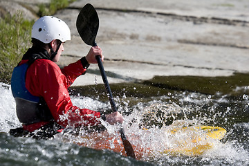 Image showing whitewater kayaker surfing on a wave