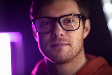 Image showing portrait of man in glasses over neon lights