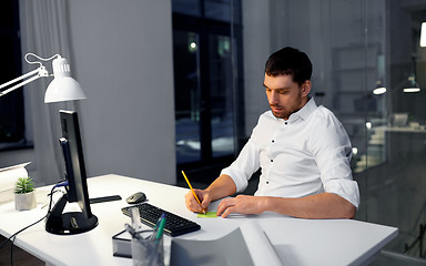 Image showing businessman with computer working at night office