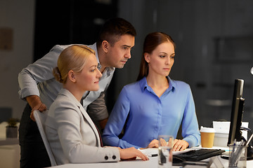 Image showing business team with computer working late at office