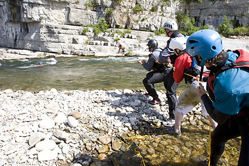 Image showing kayak paddlers practising river rescues