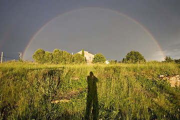 Image showing shadow of a photographer shooting a rainbow