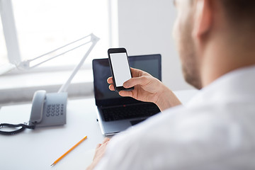 Image showing close up of businessman using smartphone at office