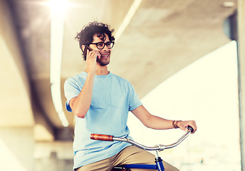 Image showing man with smartphone and fixed gear bike on street