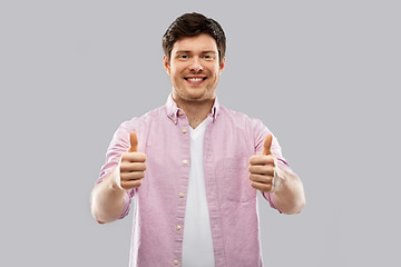 Image showing happy young man showing thumbs up