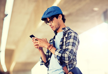 Image showing hipster man texting message on smartphone