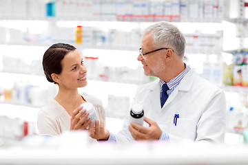 Image showing apothecary and woman with drug at pharmacy