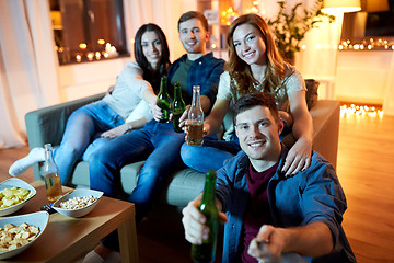 Image showing happy friends taking selfie at home party