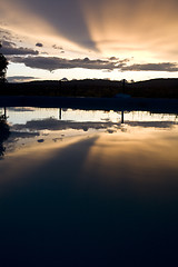 Image showing reflection of sunset over swimming pool