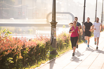 Image showing group of young people jogging in the city