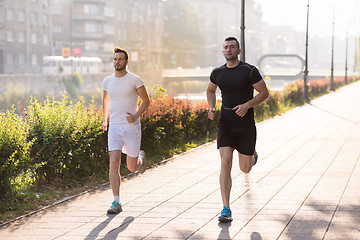 Image showing group of young people jogging in the city