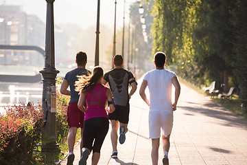 Image showing group of young people jogging in the city