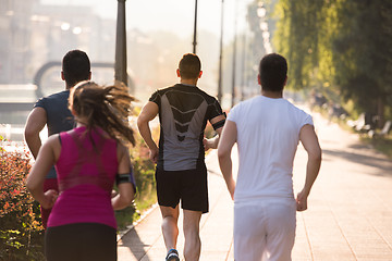 Image showing group of young people jogging in the city