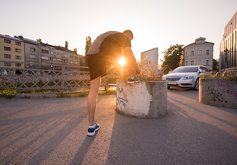 Image showing man tying running shoes laces