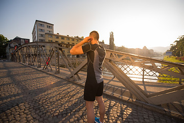 Image showing portrait of a jogging man at sunny morning