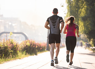 Image showing young couple jogging  in the city