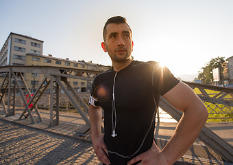 Image showing portrait of a jogging man at sunny morning