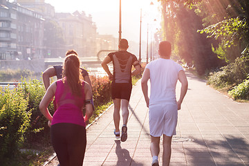 Image showing group of young people jogging in the city