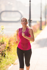 Image showing woman jogging at sunny morning