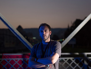 Image showing man jogging across the bridge in the city