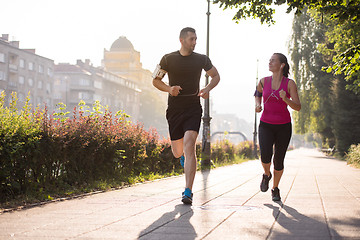 Image showing young couple jogging  in the city