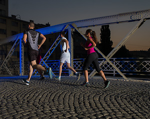 Image showing young people jogging across the bridge