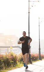 Image showing man jogging at sunny morning