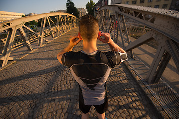 Image showing portrait of a jogging man at sunny morning