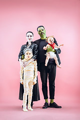 Image showing Halloween Family. Happy Father, Mother and Children Girls in Halloween Costume and Makeup