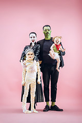 Image showing Halloween Family. Happy Father, Mother and Children Girls in Halloween Costume and Makeup