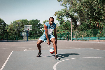 Image showing Picture of young confused african basketball player practicing