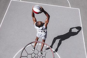 Image showing Picture of young confused african basketball player practicing