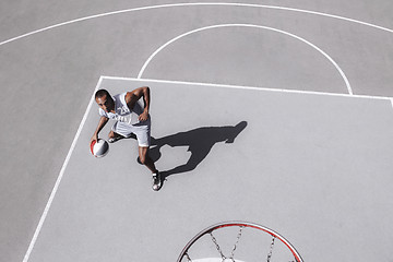 Image showing Picture of young confused african basketball player practicing