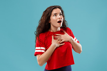 Image showing Beautiful woman looking suprised isolated on blue