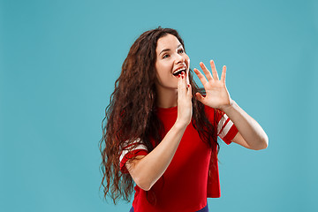 Image showing Isolated on pink young casual woman shouting at studio