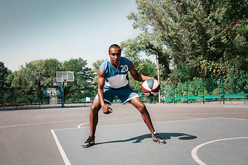 Image showing Picture of young confused african basketball player practicing