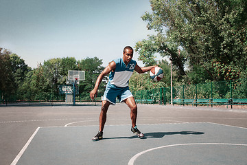 Image showing Picture of young confused african basketball player practicing