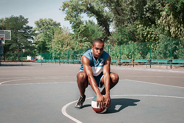 Image showing Picture of young confused african basketball player practicing