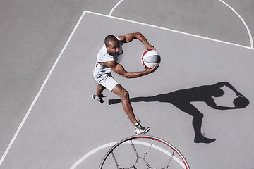 Image showing Picture of young confused african basketball player practicing