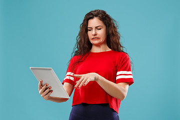 Image showing The happy businesswoman with red laptop on blue