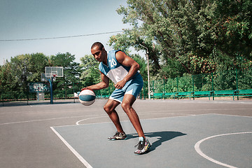 Image showing Picture of young confused african basketball player practicing