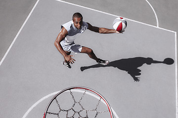 Image showing Picture of young confused african basketball player practicing