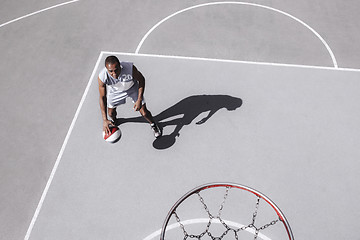 Image showing Picture of young confused african basketball player practicing