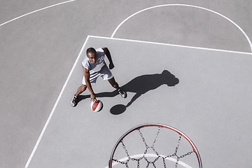 Image showing Picture of young confused african basketball player practicing