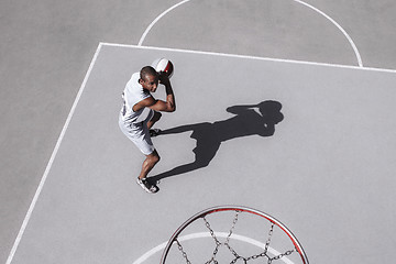 Image showing Picture of young confused african basketball player practicing