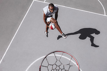 Image showing Picture of young confused african basketball player practicing