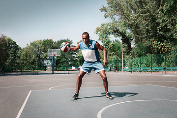 Image showing Picture of young confused african basketball player practicing