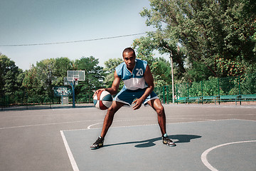 Image showing Picture of young confused african basketball player practicing