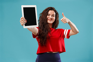 Image showing The happy businesswoman with red laptop on blue